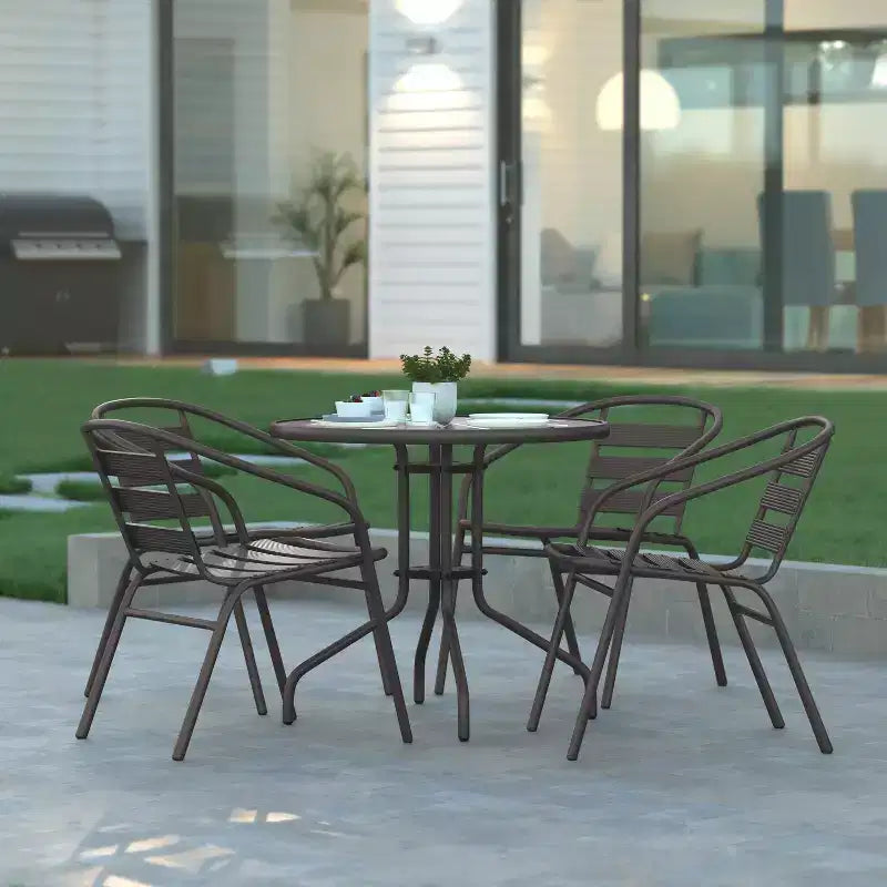 Emma and Oliver 31.5'' Round Glass Top Metal Table with 4 Aluminum Slat Stack Chairs